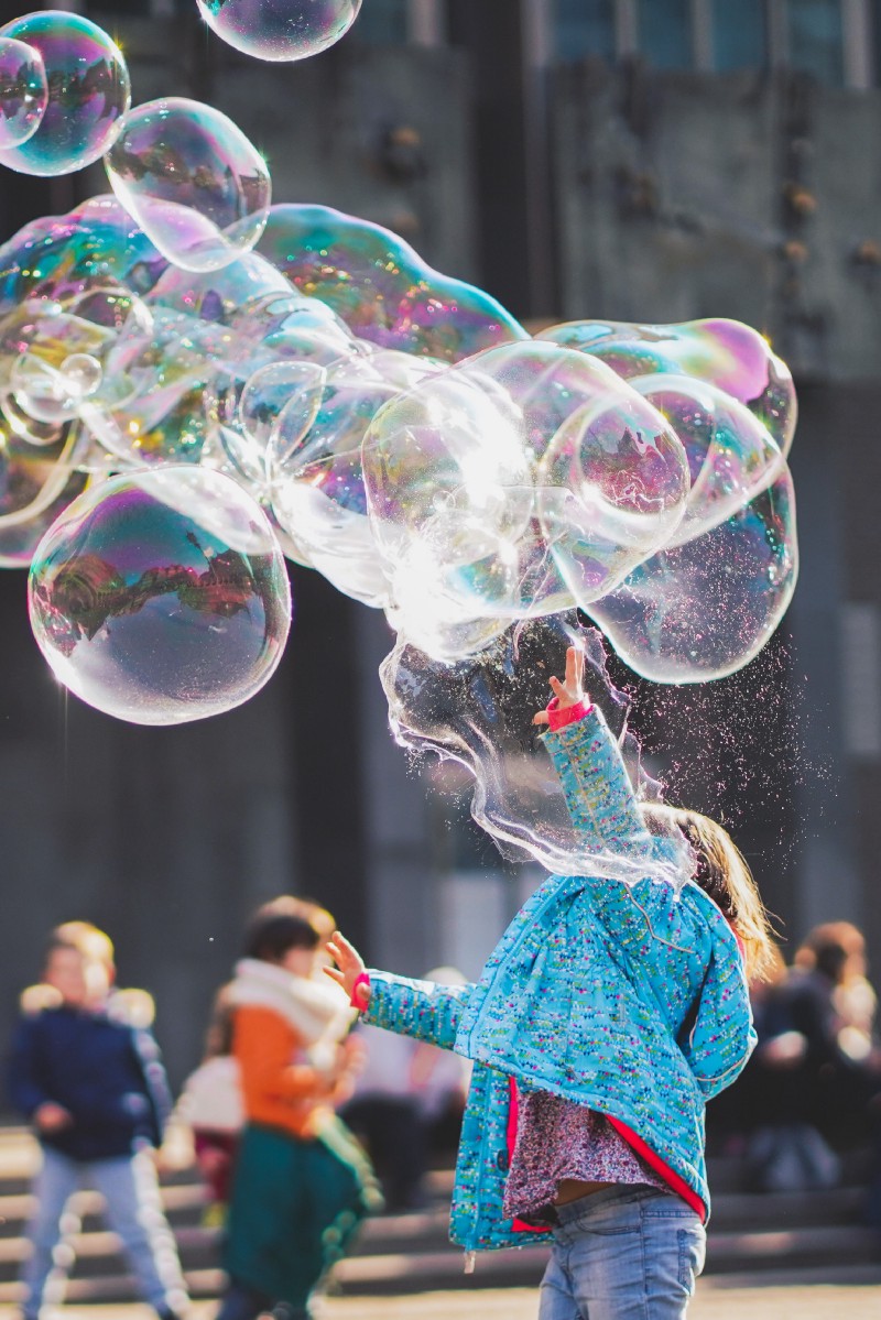 A girl playing with Bubbles